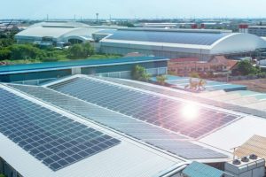 Solar panels or Solar cells on factory rooftop or terrace with sun light, Industry.